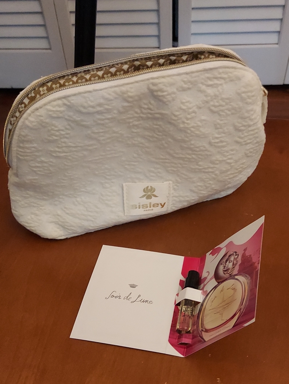 Sisley-Paris Cream Quilted Cosmetic Case with Gold Trim With Parfum Sample